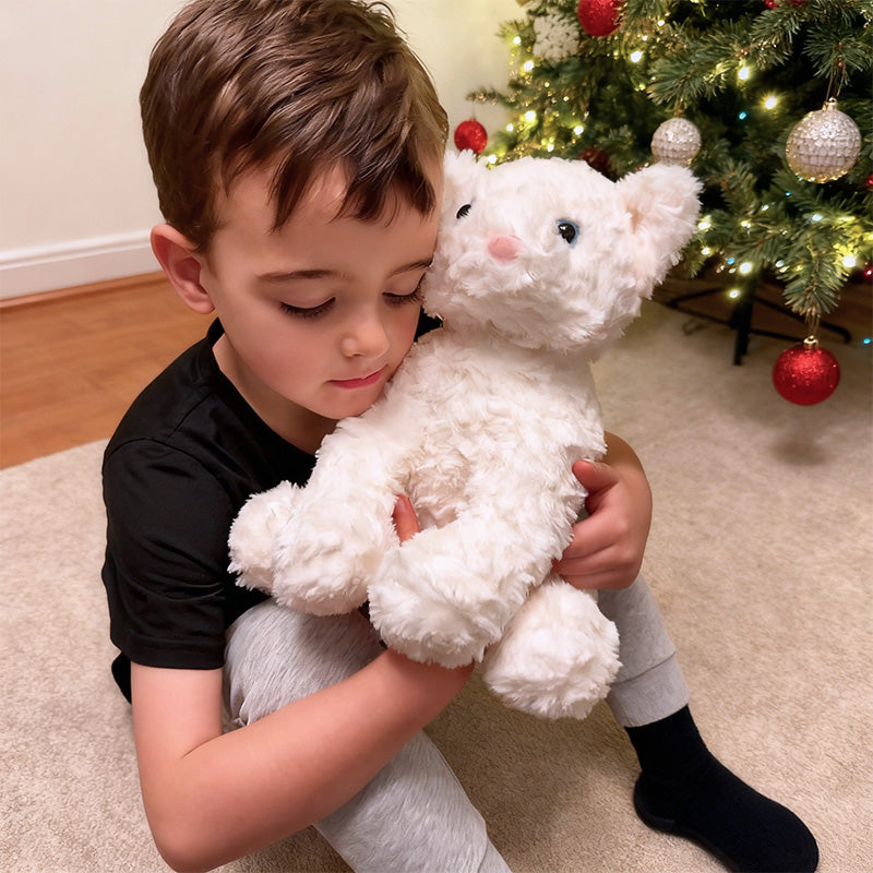Child holding TalkiPal's AI plush toy in front of a decorated Christmas tree.